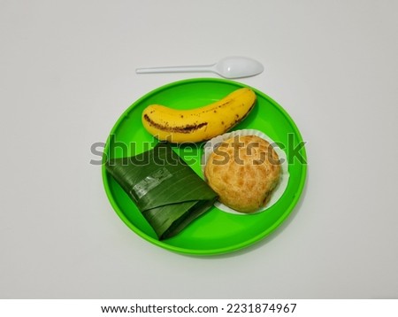 Market snacks consisting of eclairs, lemper cakes and bananas