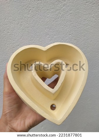 yellow heart-shaped pot on a white background