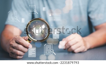 Businessman Audit documents, quality assessment management With a checklist, business document evaluation process, market data report analysis and consulting, plan review process. Royalty-Free Stock Photo #2231879793