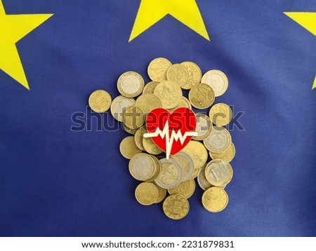 Euro coins medicine cardiology and european union flag. Cost of treatment and health insurance and care in Europe