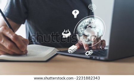 University student using laptop for studying, working or reading via internet or cyberspace. Learning or training skill course or classroom online at home. Conceptual idea of education or e-learning Royalty-Free Stock Photo #2231882343
