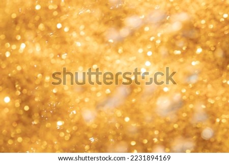 Golden abstract sparkles or glitter lights Defocused circles bokeh background