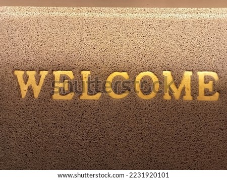 
Black foot mat with "WELCOME" lettering.