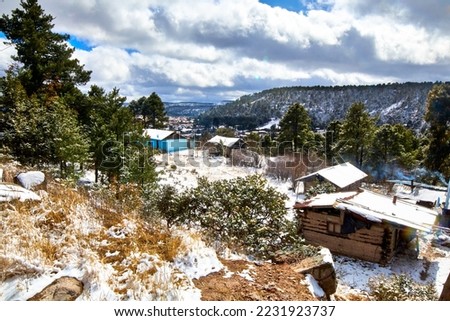 village in winter with snow covering all around, creel chihuahua  Royalty-Free Stock Photo #2231923737