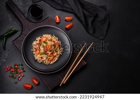 Delicious fresh noodles with sweet pepper, tomato, spices and herbs. Asian cuisine Royalty-Free Stock Photo #2231924947