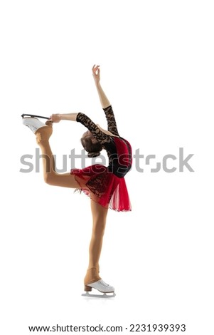 Free skating. Portrait of little flexible girl, figure skater wearing stage attire posing isolated on white studio backgound. Concept of movement, sport, beauty. Copy space for ad, text