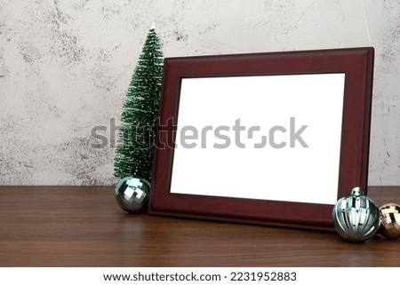Blank frame with christmas balls decorations on table. Mock up for your photo or text. Frame mockup.