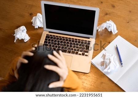 A woman stuck in computer work Royalty-Free Stock Photo #2231955651