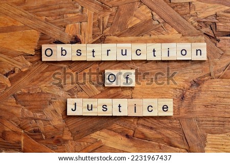 Obstruction Of Justice text on wooden square, law quotes Royalty-Free Stock Photo #2231967437