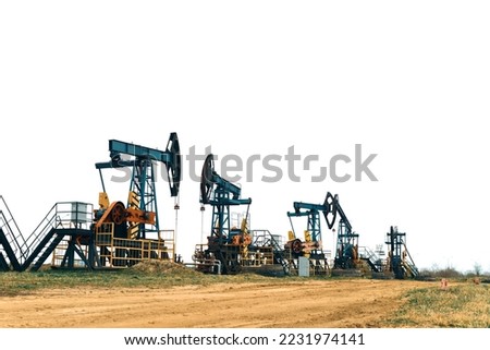 Oil Pump Jacks. Country road and Oil pumps, nodding donkey or pump jack and rig.