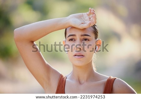 Woman, fitness and rest, tired and breathing on a running break, listening to music on earphones on summer morning in Australia. Health, exercise and girl runner resting on outdoor workout.