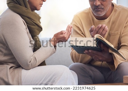 Worship, prayer and Muslim couple with a quran, reading and studying spiritual faith in their house. Religion, gratitude and holy and Islamic man and woman with a bible during Ramadan praying