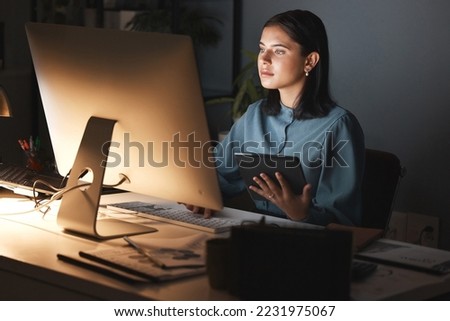 Night office, computer and business woman with tablet for digital marketing, seo analytics and multimedia application review. Website design, graphic designer and creative employee in dark workspace Royalty-Free Stock Photo #2231975067