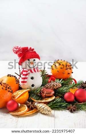 Snowman and Christmas decorations on table, light abstract background. Festive winter time concept. Christmas and new year holidays. winter seasonal decorative composition