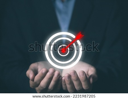 businessman showing target and arrow icon Virtual digital technology. concept of business investment objectives and goals, marketing strategies and aims for success