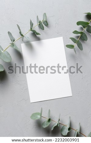 Wedding invitation card mockup with natural eucalyptus twigs