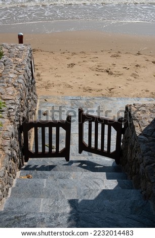 Small wooden gate to a sea beach in a resort, keeping guests their privacy space.