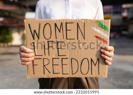 Woman protesting for women's rights in Iran Royalty-Free Stock Photo #2232015995