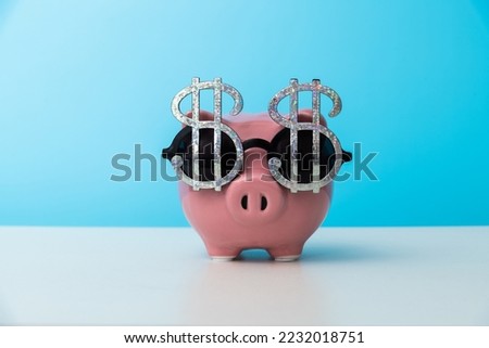 Piggy bank wears glasses with dollar sign
