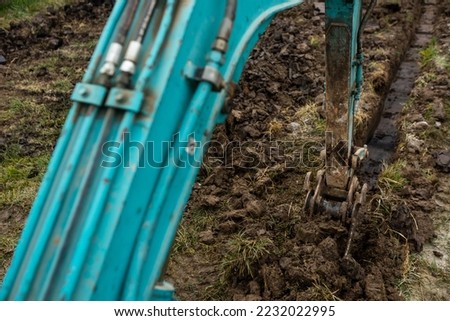 Close up of excavator or digger digging some a soil or clay, industrial concept