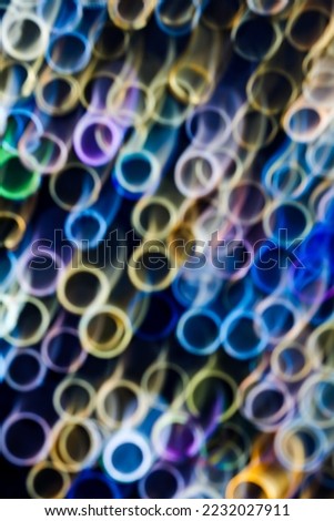 Abstract colorful rings on black background with intentionally blurred main subject for artistic purposes