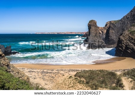 ocean view in Portugal. coast, steep cliffs, empty beaches, wild nature. The rock walls of the coast. waves on the ocean. West coast of Portugal. Daylight, horizontal