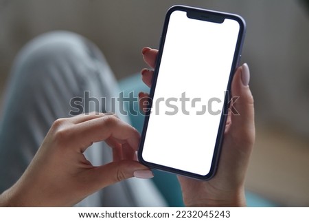 Close up Mock up white screen blank close up mobile phone in woman hands holding Back view