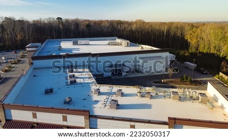 Large grocery store and strip mall with rooftop units for all in one HVAC solution in Flowery Branch, Georgia, USA.  Aerial view heating and air conditioning system in commercial building supermarkets Royalty-Free Stock Photo #2232050317