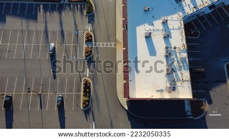 Large grocery store near busy service road outdoor parking lots, row of rooftop units all in one HVAC solution Atlanta, Georgia.  Aerial view heating and air conditioning system in commercial building Royalty-Free Stock Photo #2232050335