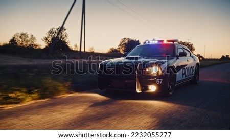 Highway Traffic Patrol Car In Pursuit of Criminal Vehicle. Police Officers in Squad Car Chase Suspect on Industrial Area Road. Cinematic Atmospheric High Speed Action Scene Royalty-Free Stock Photo #2232055277
