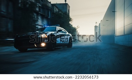 Traffic Patrol Car in Pursuit of Criminal Vehicle. Police Officers in Squad Car Chasing Suspect on Industrial Road, Sirens Blazing, High Speed. Stylish Cinematic Shot of Action Scene Royalty-Free Stock Photo #2232056173