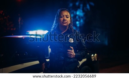 Professional Blaсk Female Police Officer Looking at the Camera. Policewoman Maintains public order and safety, Enforcing the Law, Prevents and Investigates Criminal Activity. Medium Portrait Royalty-Free Stock Photo #2232056689