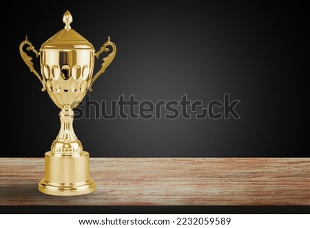 Big golden Cup Trophy on the desk Royalty-Free Stock Photo #2232059589