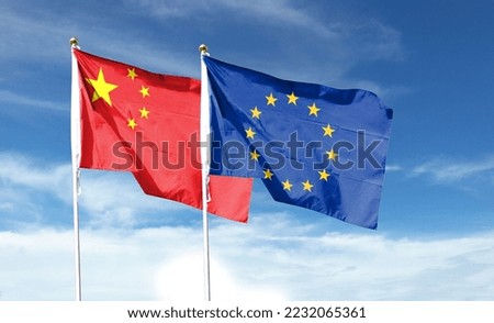 China flag and EU flag on cloudy sky. Waving in the sky  Royalty-Free Stock Photo #2232065361