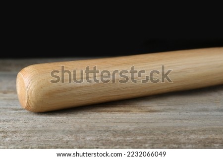 Baseball bat on wooden table. Sports equipment