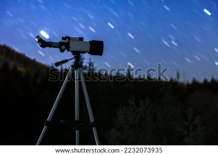Modern telescope under night sky with star trails outdoors. Learning astronomy Royalty-Free Stock Photo #2232073935