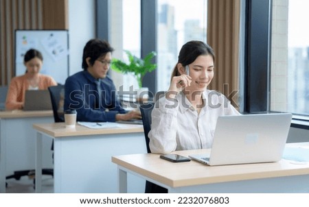 Group of businesspeople in smart casual clothes working together in office.