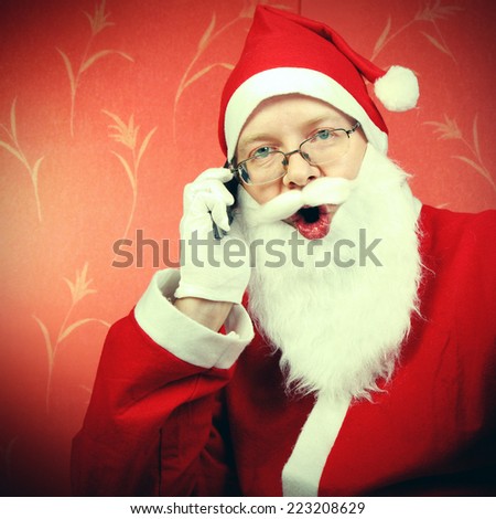 Toned Photo of Happy Santa Claus talking on Cellphone