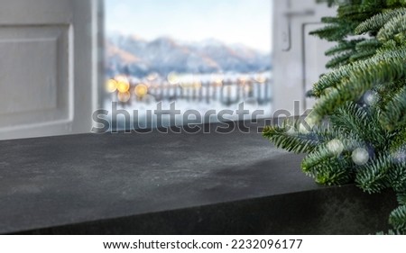 A stone table on a winter christmas evening with a free seat