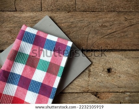 Napkin and book on wood background 