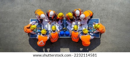 Top view of architectural engineering working on solar panels and his blueprints with Solar photovoltaic equipment on construction site. meeting, discussing, designing, planning, Clean energy concept Royalty-Free Stock Photo #2232114581