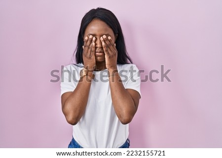 African young woman wearing casual white t shirt rubbing eyes for fatigue and headache, sleepy and tired expression. vision problem 