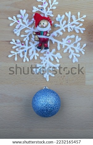 festive composition with New Year's toys on a light wooden background