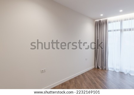a large bright empty room with lighting. the interior design