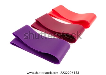 fitness elastic band. Woman showing a blue rubber band. Sport and healthy active lifestyle concept. A set of colorful elastic fitness band.  Royalty-Free Stock Photo #2232206153