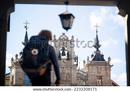 Way of St James , Camino de Santiago , pilgrim unfocused walking  to Compostela  with backpack on central square of Astorga city , Leon, Spain Royalty-Free Stock Photo #2232208171