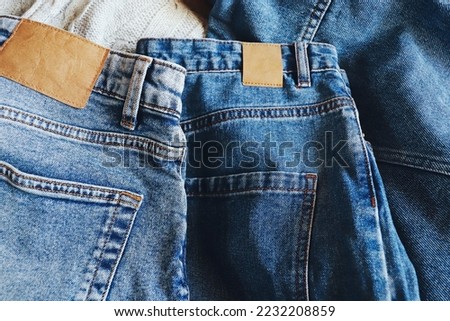 Trendy blue denim pants. New Jeans collection. Closeup clothes photography. Fashion background for design