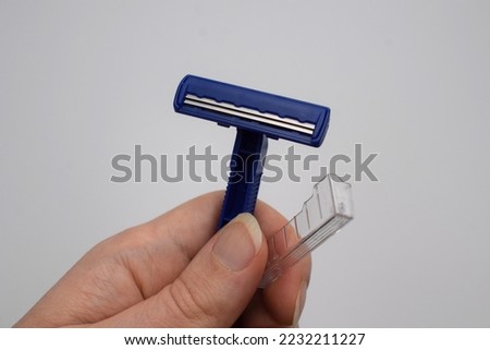 Disposable razor blade for face and body hair shaving isolated on white background Royalty-Free Stock Photo #2232211227