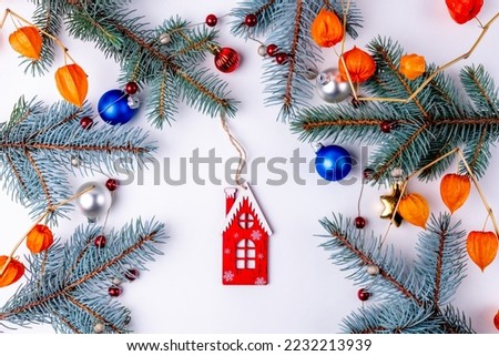 Christmas decoration, branches of a Christmas tree on a wooden background. Wedding rings.