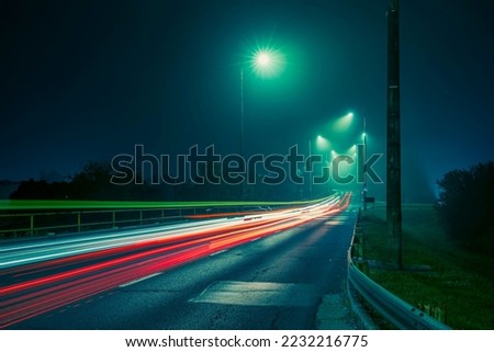Traffic lights at foggy night, long exposure photography